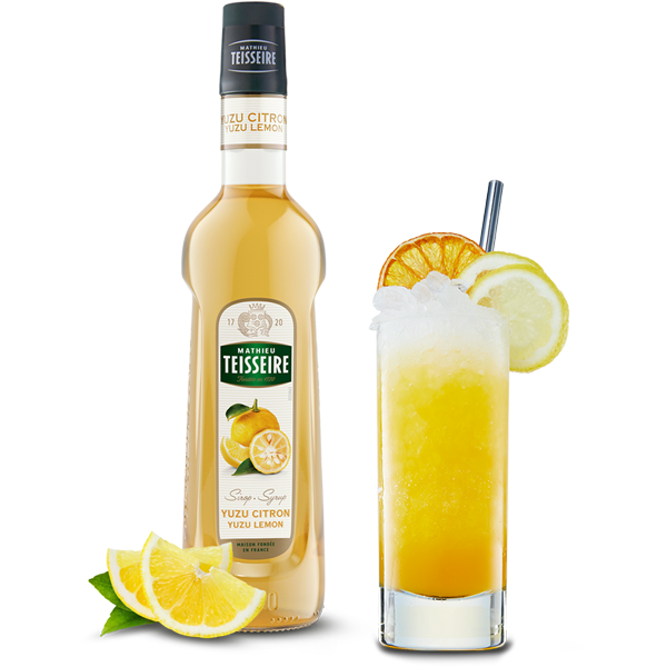 Bottle of Teisseire Yuzu Citron syrup with a glass of lemon-themed cocktail on a white background